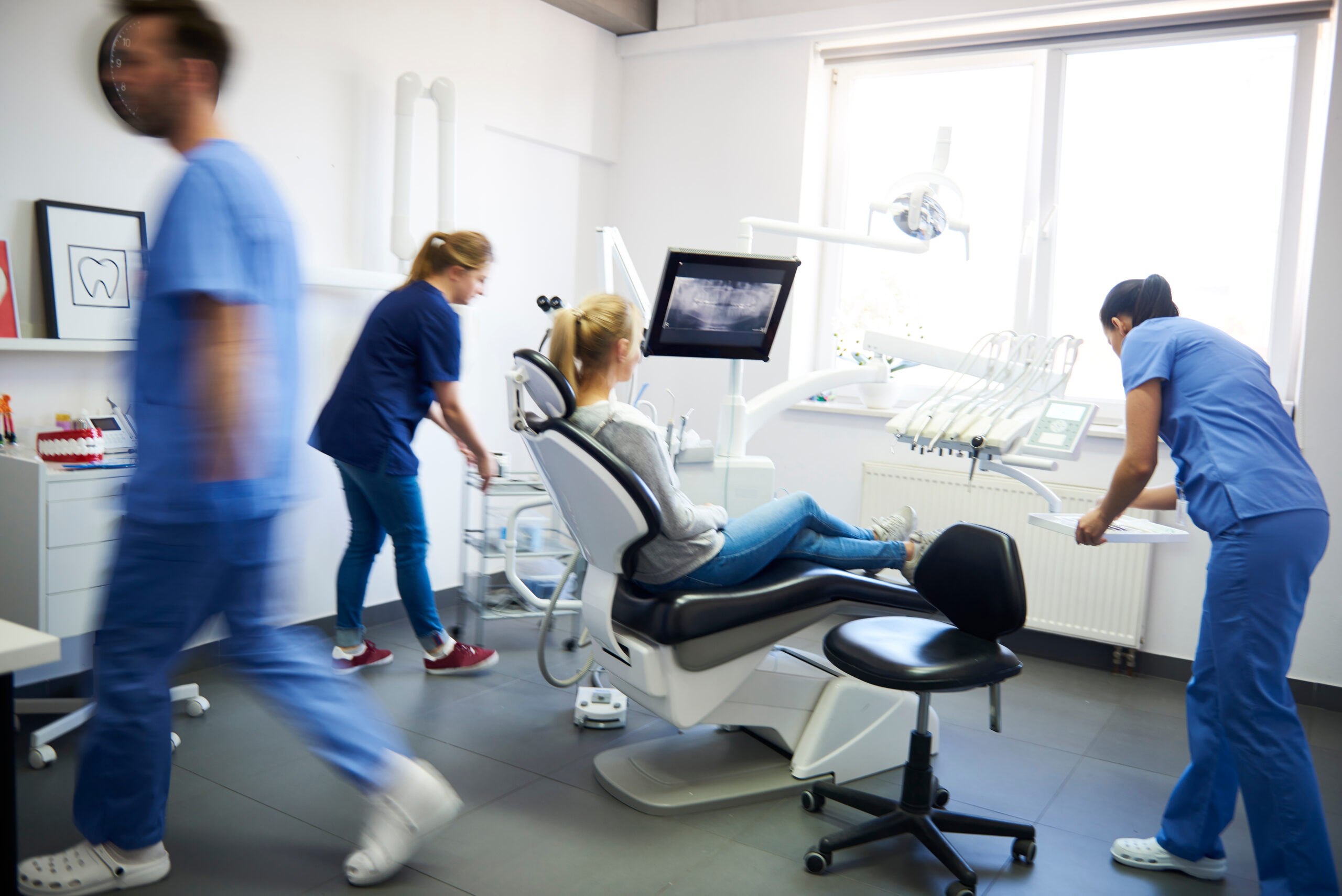 blurred view of dentists rendering emergency care in Fresno