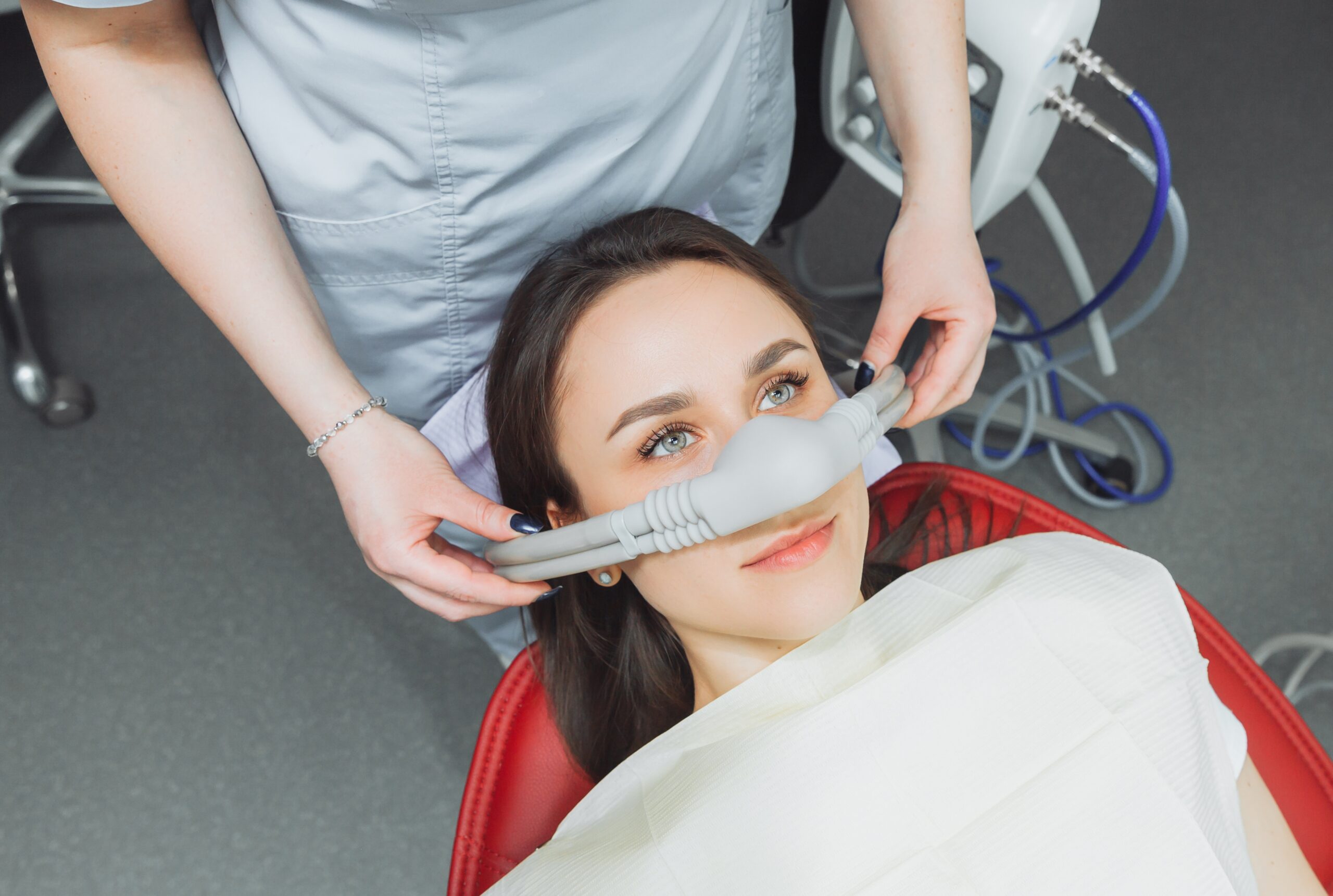 doctor placing a sedation device over a relaxed patients nose