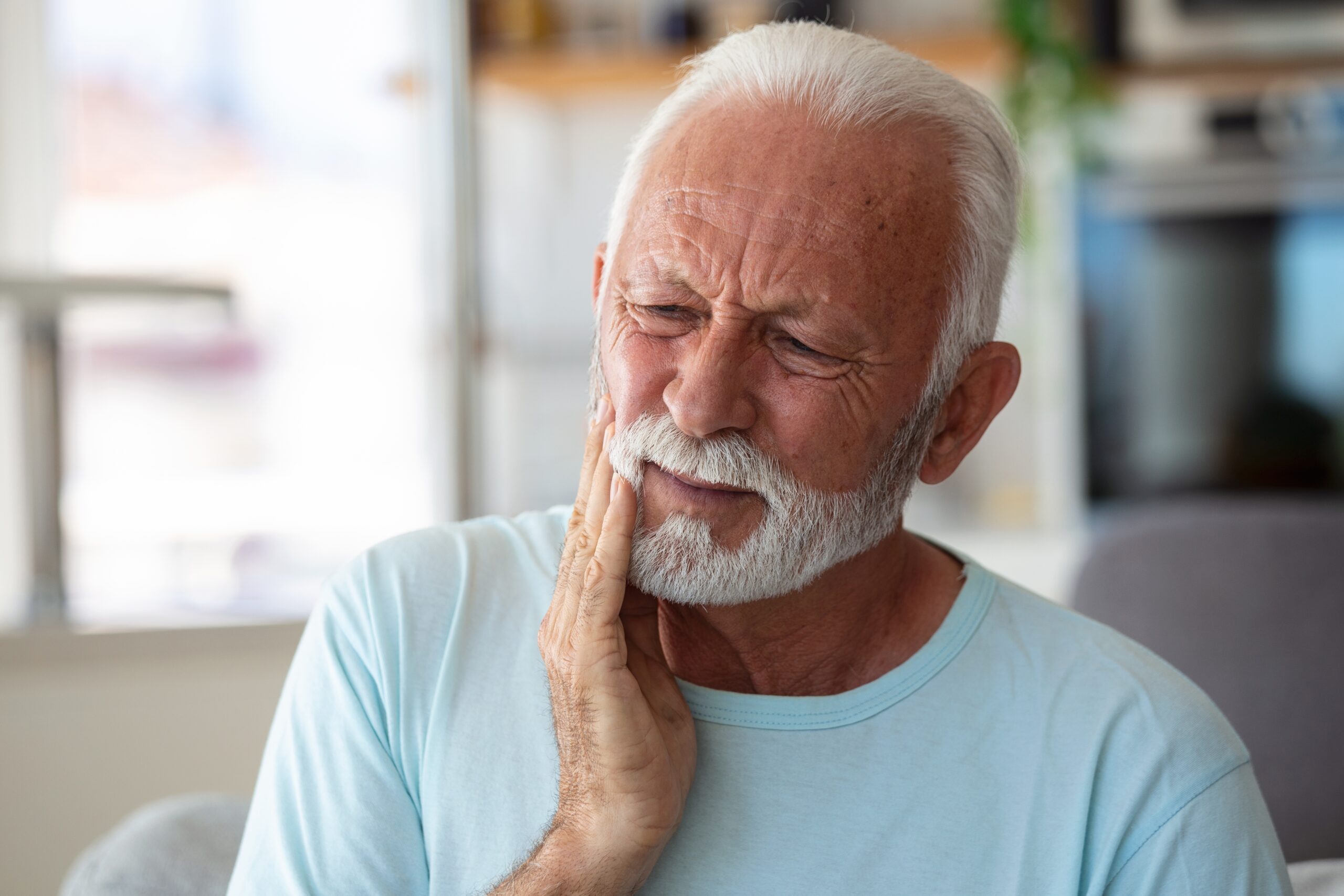 Senior Man Suffering From Terrible Strong Teeth Pain, Touching Cheek With Hand.
