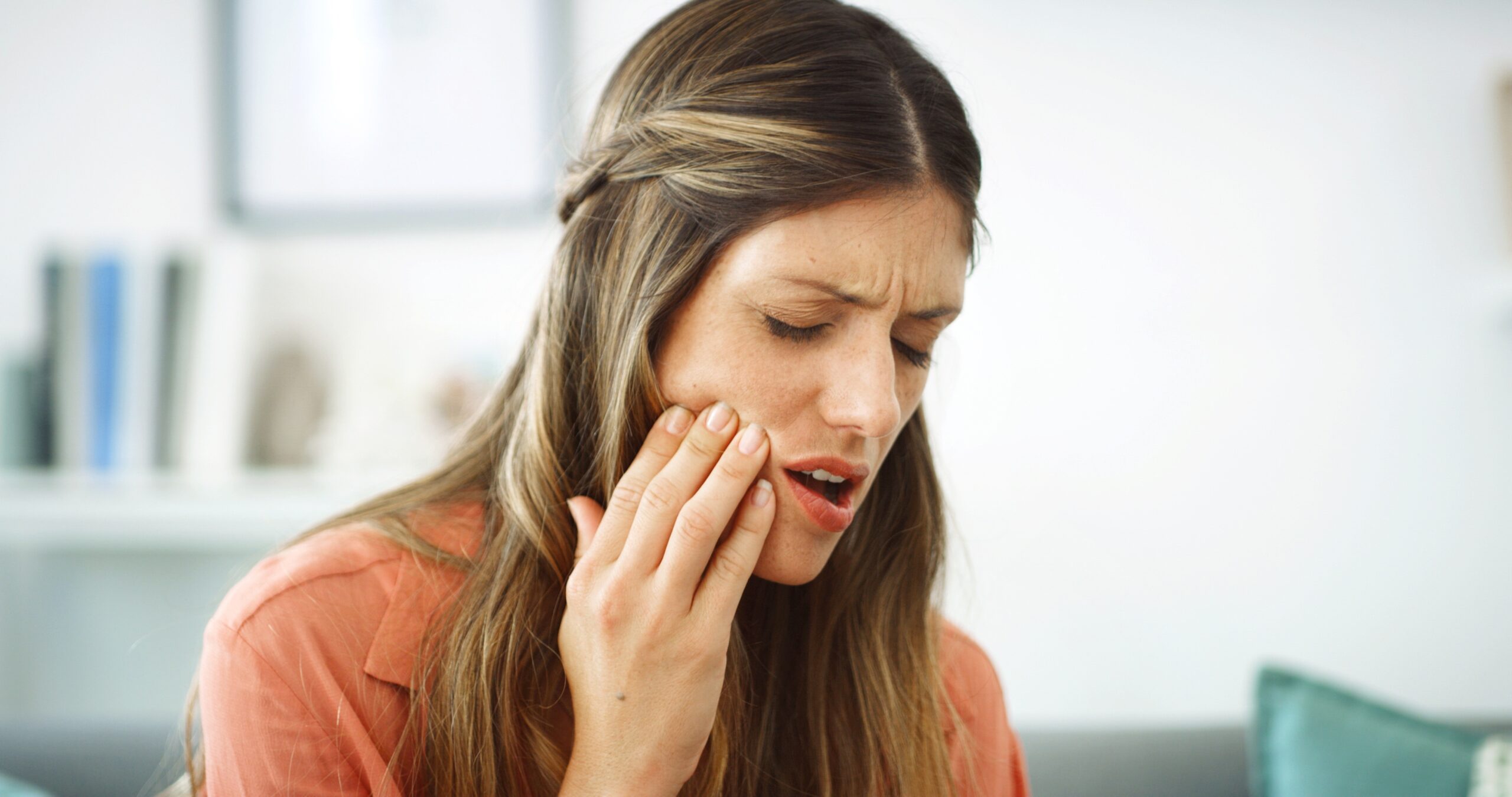 Woman, pain and infection with tooth ache for dental issue, oral or gum disease at home